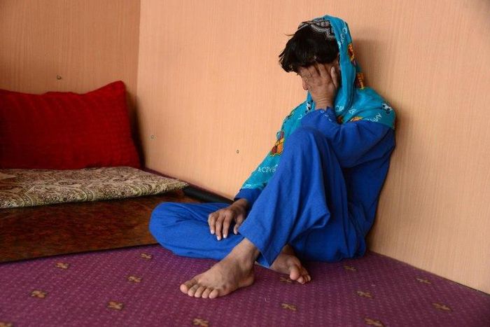 An Afghan boy, who was held as a child sex slave, sits at a restaurant in a unidentified location in Afghanistan