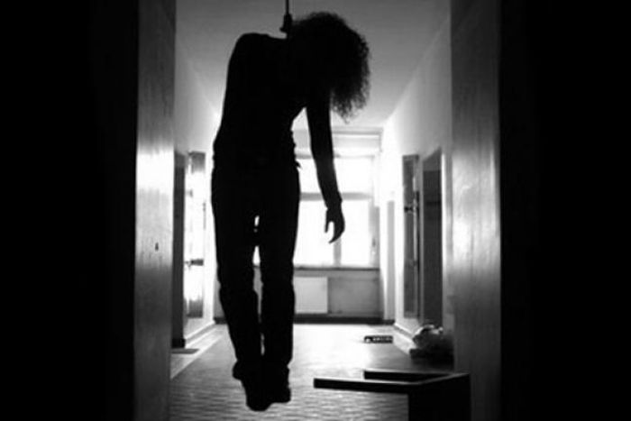 A body hanging from the ceiling of a house