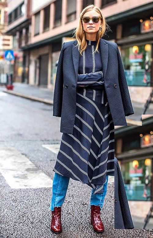 This striped dress is layered over a pair of jeans and paired with a sharp blazer