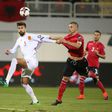Albania's Ansi Agolli (R) clashes with Spain's Gerard Pique in Shkoder, on October 9, 2016