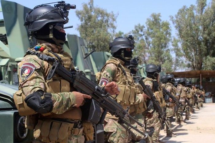 Iraqi police forces stand in front of armoured vehicles at the Habbaniyah base, east of Ramadi in Anbar province, in May 2016, ahead of a military operation against the Islamic State group in the Rutba area