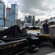 A Techeetah car is seen as other team members walk past in the pit lane of the Formula E track in Hong Kong