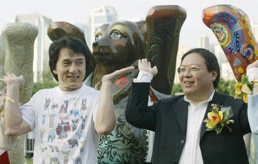 Former Hong Kong home affairs secretary Patrick Ho Chi Ping (R), pictured in a 2003 photograph with movie star Jackie Chan, was sentenced to three years in prison over a bribery scheme