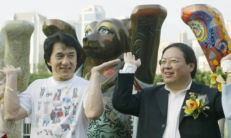 Former Hong Kong home affairs secretary Patrick Ho Chi Ping (R), pictured in a 2003 photograph with movie star Jackie Chan, was sentenced to three years in prison over a bribery scheme