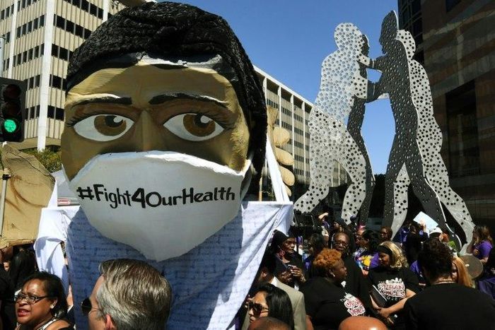 Protesters march outside the Federal Building during a "Save the Affordable Care Act" (Obamacare) rally in Los Angeles
