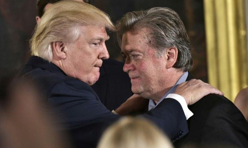 US President Donald Trump (left) congratulates Steve Bannon during a ceremony at the White House in January 2017