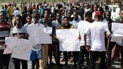 Protesters protesting the xenophobic attacks in India