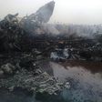 people gathering near a plane wreckage after a jet crash-landed, leaving at least 37 people injured on March 20, 2017 in South Sudan's northwestern city of Wau