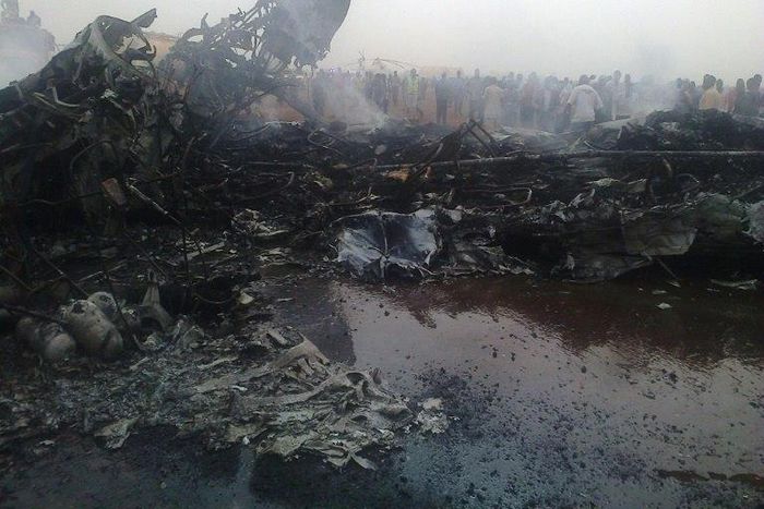 people gathering near a plane wreckage after a jet crash-landed, leaving at least 37 people injured on March 20, 2017 in South Sudan's northwestern city of Wau
