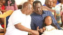 ODM party leader Raila Odinga speaks with hie elder brother Oburu Odinga at a past public event