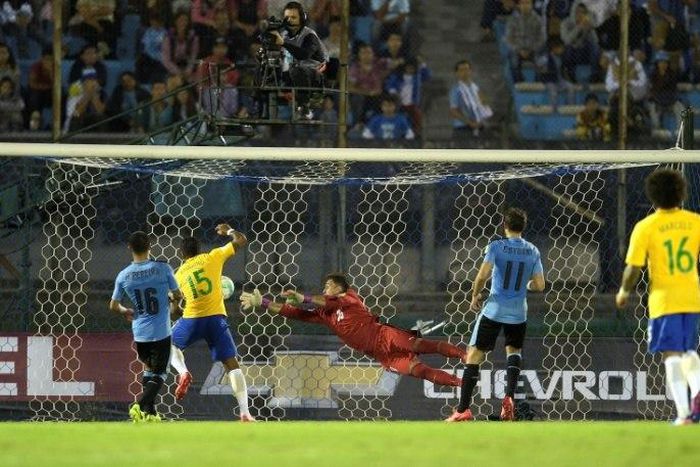 Paulinho (2nd-L) scores the second of his three goals as Brazil thrash Uruguay 4-1 in World Cup qualifiers