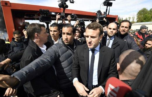 Macron arrived at the Whirlpool factory surrounded by a large scrum of reporters