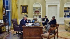 US President Donald Trump speaks on the phone with Australians Prime Minister Malcolm Turnbull, alongside Chief Strategist Steve Bannon (R) and National Security Advisor Michael Flynn, in the Oval Office on January 28, 2017