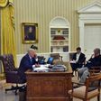 US President Donald Trump speaks on the phone with Australians Prime Minister Malcolm Turnbull, alongside Chief Strategist Steve Bannon (R) and National Security Advisor Michael Flynn, in the Oval Office on January 28, 2017