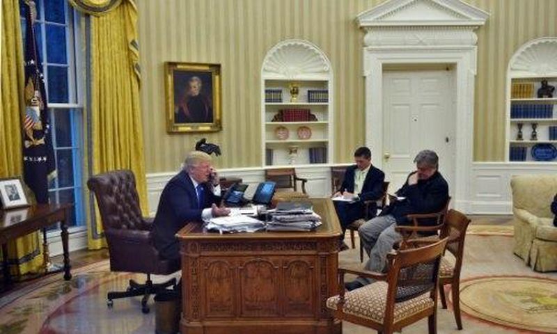 US President Donald Trump speaks on the phone with Australians Prime Minister Malcolm Turnbull, alongside Chief Strategist Steve Bannon (R) and National Security Advisor Michael Flynn, in the Oval Office on January 28, 2017