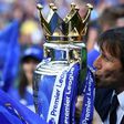 Chelsea's head coach Antonio Conte kisses the English Premier League trophy on May 21, 2017