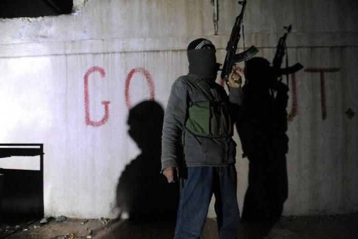 A Free Syrian Army rebel stands guard in the north Syrian city of Binnish
