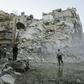 Members of the Syrian Civil Defence search for victims amid the rubble of a destroyed building in Aleppo, on October 17, 2016