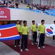 Flags of North Korea (L) and South Korea are carried prior to a football match between the two countries' U-23 teams during the Vietnam Football (VFF) Federation Son Ha Cup tournament on November 4, 2010