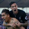 Liverpool's Brazilian midfielder Roberto Firmino (L) celebrates scoring his team's second goal with teammate Coutinho during their match against Stoke City in Stoke-on-Trent, central England on April 8, 2017