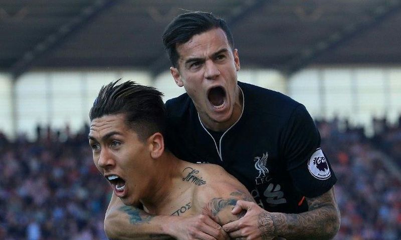 Liverpool's Brazilian midfielder Roberto Firmino (L) celebrates scoring his team's second goal with teammate Coutinho during their match against Stoke City in Stoke-on-Trent, central England on April 8, 2017