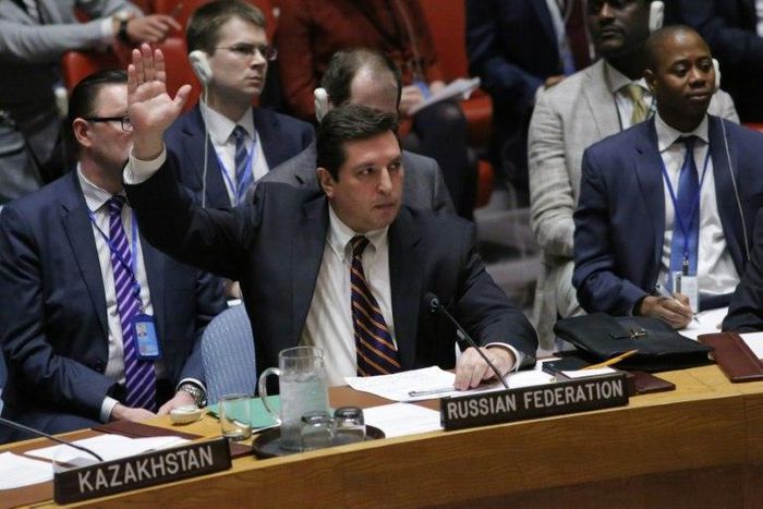 Russian Deputy Permanent Representative to the United Nations Vladimir Safronkov holds up his hand as he votes against a Draft resolution that condemns the reported use of chemical weapons in Syria at the Security Council on April 12, 2017