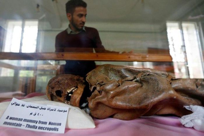 A Yemeni student looks at a millennia-old mummy on display at Sanaa University