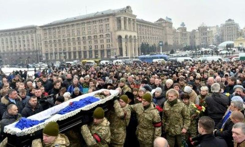 Mourners gather in Kiev's Independence (Maidan) Square on February 1, 2017, as servicemen carry the coffins of soldiers killed in eastern Ukraine