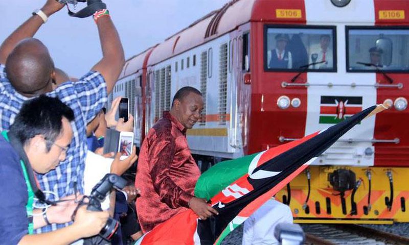 President Uhuru Kenyatta flags off one of the SGR trains during the launch of the cargo service on May 30