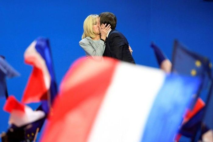 France's incoming president Emmanuel Macron kisses his wife Brigitte after his victory in the first round of the election in April