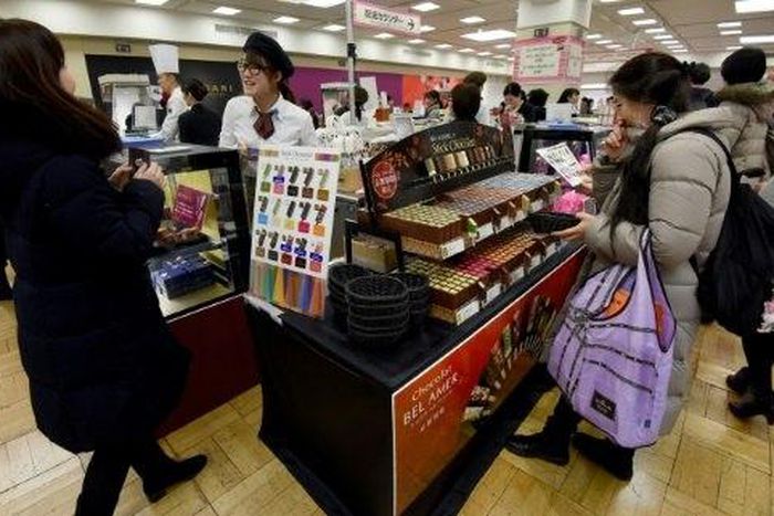 Women in Japan mark Valentine's Day by buying so-called 'obligation chocolate' for boyfriends, husbands, colleagues and bosses