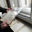 Historian Mikhail Melnichenko holds pages from a Stalin-era diary during an interview with AFP, in Moscow