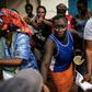 A woman (C) supportring the incumbent Gambian president Yahya Jammeh, quarrels with supporters of opposition leader Adama Barrow in Banjul