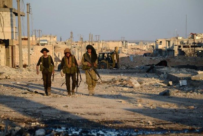 Turkish-backed Syrian rebels patrol through the town of al-Bab shortly after they captured it from the Islamic State (IS) group