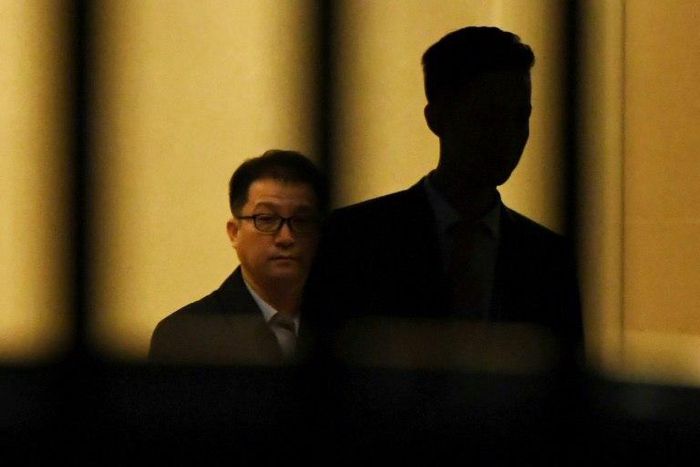 A North Korean official pushes a cart through the VIP entrance at Beijing airport after a flight from Malaysia believed to be carrying the body of Kim Jong-Nam arrived in the Chinese capital