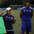Head coach of Eastern FC, Chan Yuen-ting, talks to her players during a training session in Hong Kong