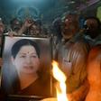 Supporters hold a photograph of Tamil Nadu state leader Jayalalithaa Jayaram as they offer prayers for her well being at a temple in Mumbai on December 5, 2016