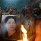 Supporters hold a photograph of Tamil Nadu state leader Jayalalithaa Jayaram as they offer prayers for her well being at a temple in Mumbai on December 5, 2016