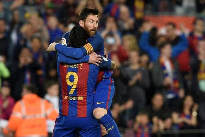 Barcelona's forward Lionel Messi (R) celebrates with Barcelona's forward Luis Suarez after scoring a goal during the Spanish league football match FC Barcelona vs Real Sociedad at the Camp Nou stadium in Barcelona on April 15, 2017