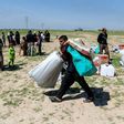 A displaced Iraqi receives humanitarian aid supplies at a camp for the internally displaced, in Salamiyah village east of Mosul, on March 27, 2017