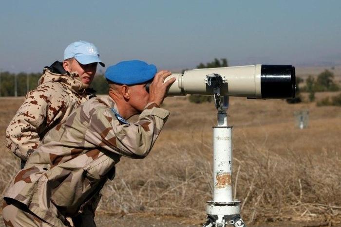 A UN officer monitors the Israel-Syria border in the Israeli-annexed Golan Heights, on November 27, 2016