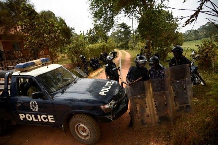 Ugandan policemen keep guard outside the home of an opposition leader in Kasangati, a Kampala suburb on February 20, 2016