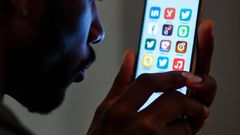 An illustrative image of a man holding a smartphone