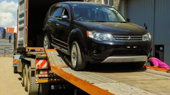 A vehicle being offloaded from a truck