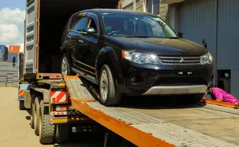 A vehicle being offloaded from a truck