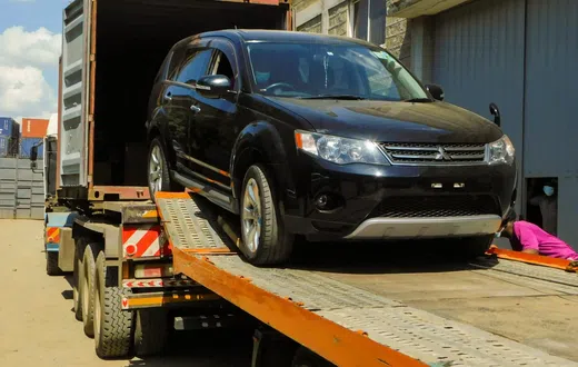 A vehicle being offloaded from a truck