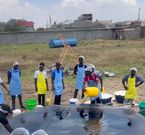 A team of chefs oil a giant pan, used to attempt to make the World's Largest Chapati by content creator Raymond Kahuma