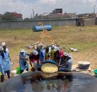 A team of chefs transfer the dough to a giant frying pan, used to attempt making the Word's Largest Chapati