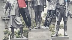 A group of young protesters climbed and posed on the Dedan Kimathi monument in Nairobi during the anti-Finance Bill protests on June 18, 2025.