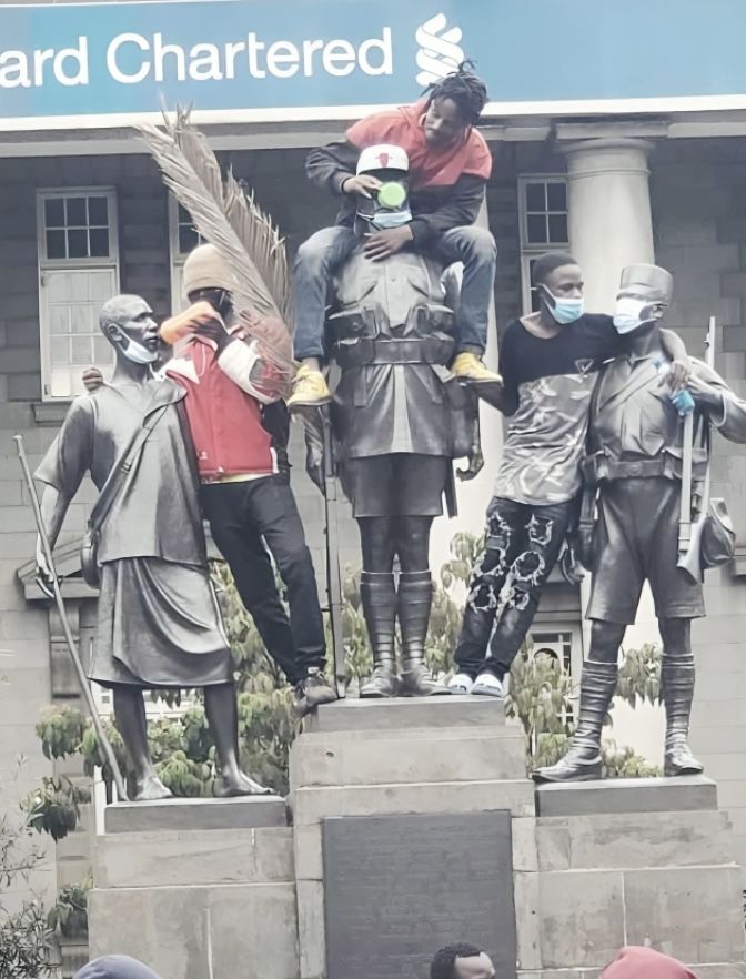 A group of young protesters climbed and posed on the Dedan Kimathi monument in Nairobi during the anti-Finance Bill protests on June 18, 2025.